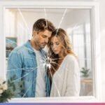 young couple looking into a broken mirror symbolizing emotional breakup and reflection